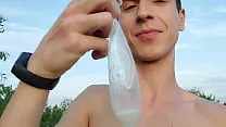 Twink boy found again a filled up condom while nude beach cruising so he put his dick in it & loaded