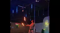 Dancer Destiny Mae dancing and playing with fire on stage at the strip club